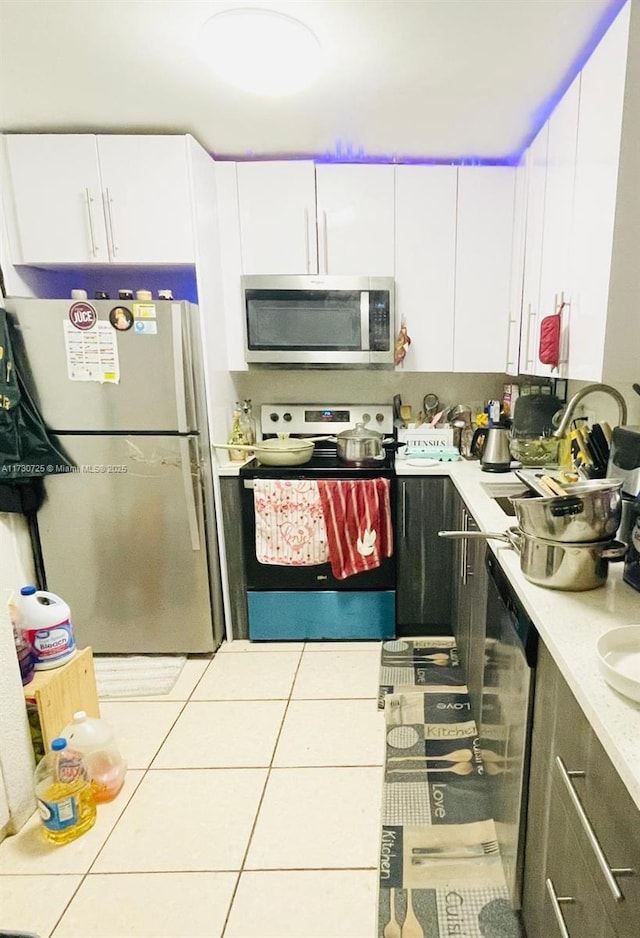 1401 NE 191st St Unit D112, Miami, FL 33179 - kitchen featuring tile patterned floors, appliances with stainless steel finishes, light countertops, and a sink