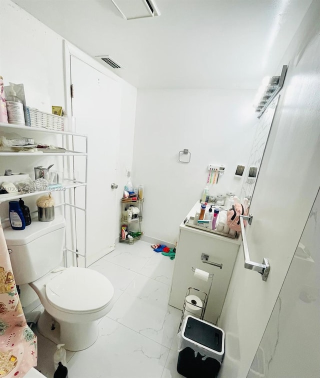 1401 NE 191st St Unit D112, Miami, FL 33179 - bathroom with visible vents, baseboards, toilet, and marble finish floor