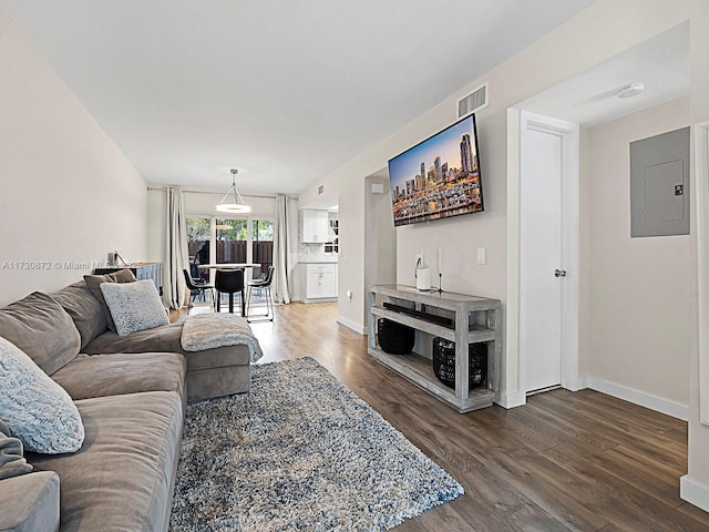 living room featuring hardwood / wood-style flooring and electric panel