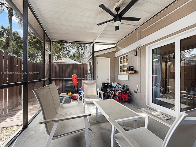 sunroom featuring ceiling fan