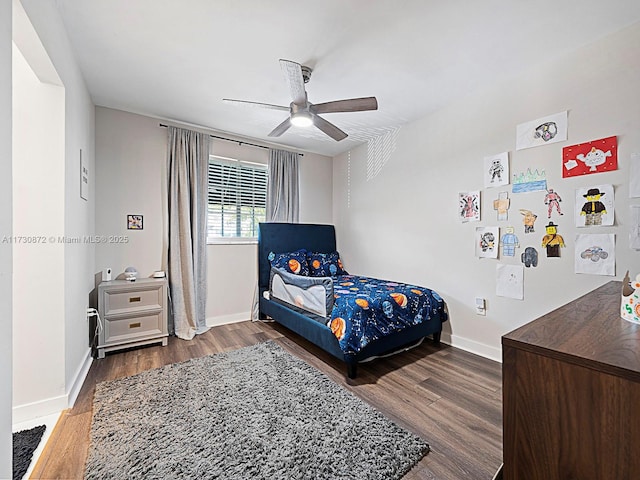 bedroom with ceiling fan and dark hardwood / wood-style flooring