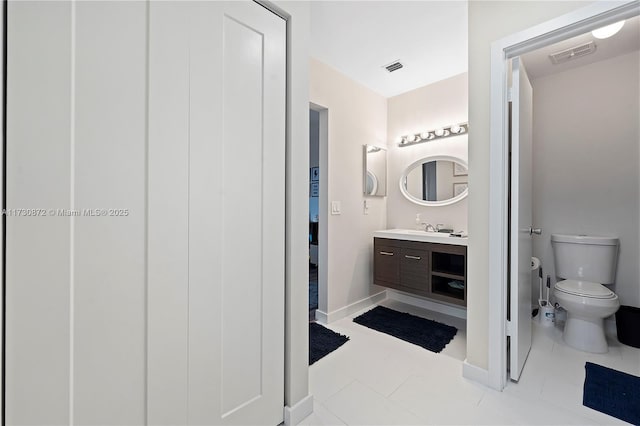 bathroom featuring tile patterned floors, vanity, and toilet