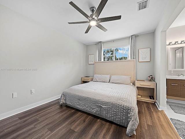 bedroom featuring ceiling fan, dark wood-type flooring, connected bathroom, and sink