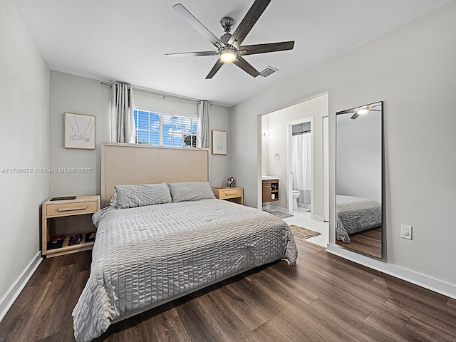 bedroom featuring ceiling fan, dark hardwood / wood-style floors, and ensuite bath