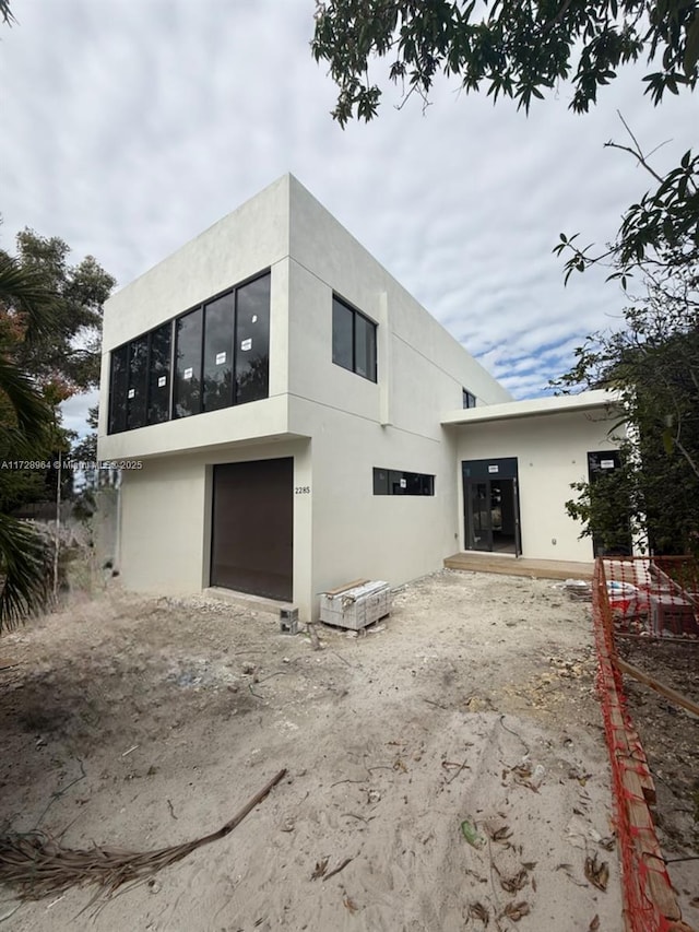 rear view of property featuring a garage