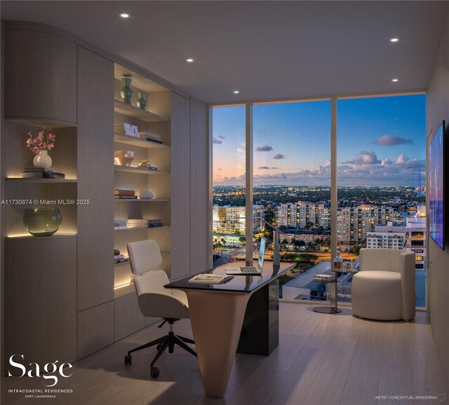 office space with floor to ceiling windows, light hardwood / wood-style floors, and built in shelves