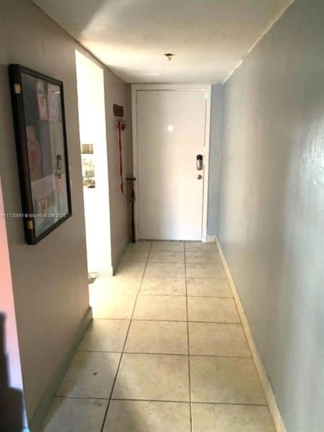 corridor with light tile patterned floors