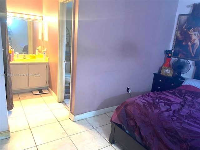 bedroom with light tile patterned floors and sink