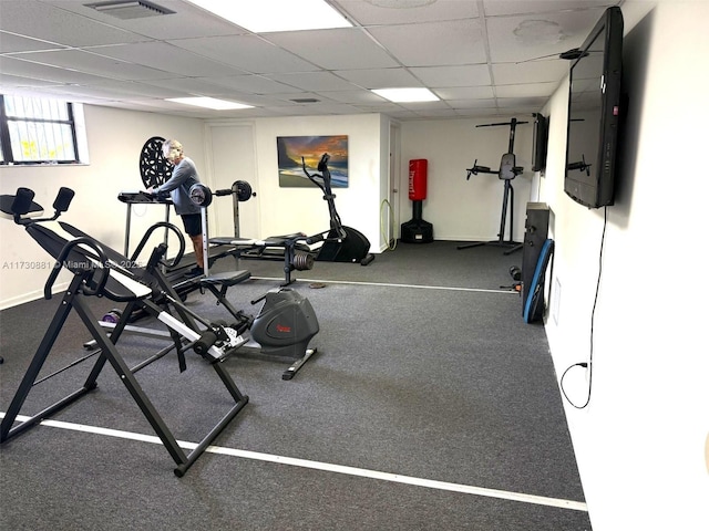 gym with a paneled ceiling