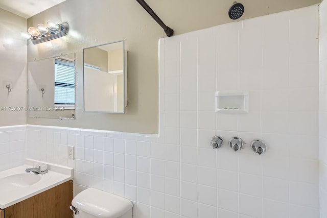 bathroom featuring a shower, toilet, and vanity