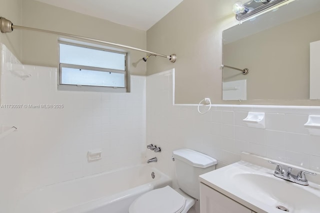 full bathroom featuring vanity, toilet, tile walls, and tiled shower / bath combo