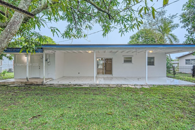 rear view of property with a lawn