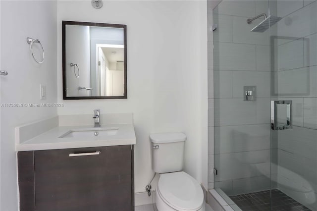 bathroom with a shower with door, vanity, and toilet