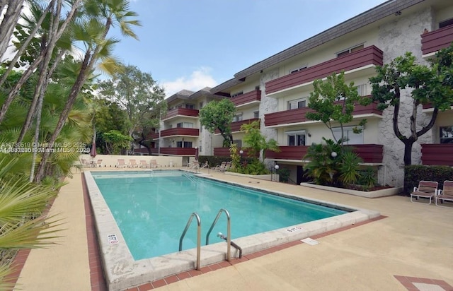 view of swimming pool featuring a patio area