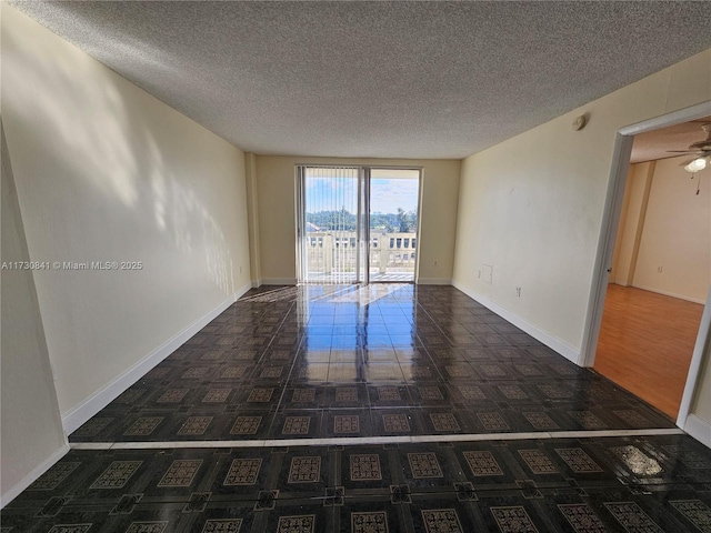 unfurnished room featuring a textured ceiling