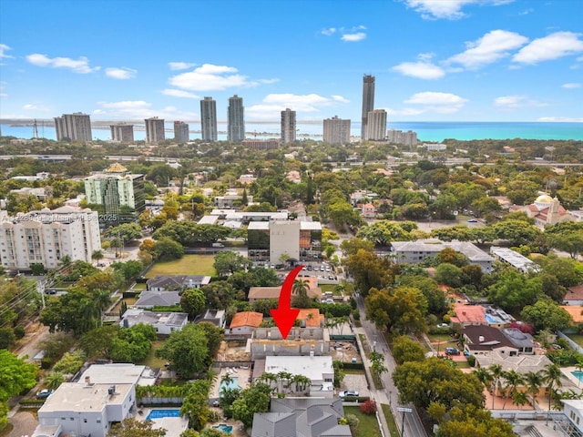drone / aerial view featuring a view of city and a water view