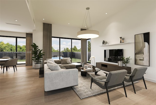 living room featuring recessed lighting, light wood-style flooring, a high ceiling, and baseboards