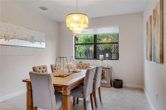 tiled dining area featuring a notable chandelier