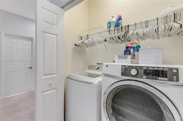 washroom featuring light carpet and independent washer and dryer