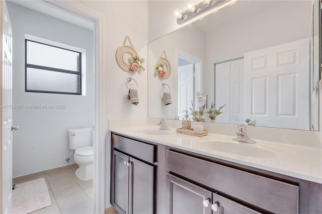 bathroom featuring toilet, vanity, and tile patterned flooring