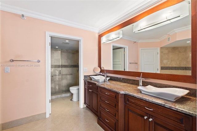 bathroom with vanity, ornamental molding, an enclosed shower, and toilet