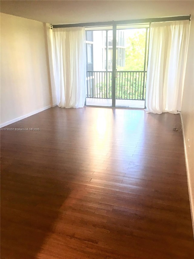 unfurnished room with dark wood-type flooring