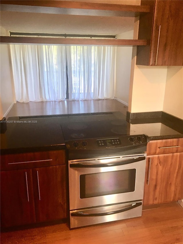 kitchen with light wood-type flooring and electric range