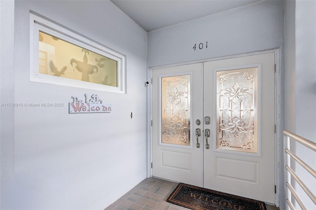 interior space with dark tile patterned flooring and french doors