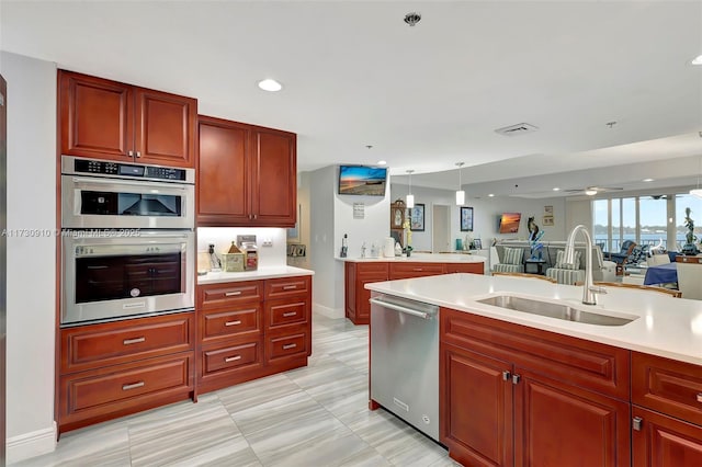 kitchen with hanging light fixtures, stainless steel appliances, and sink