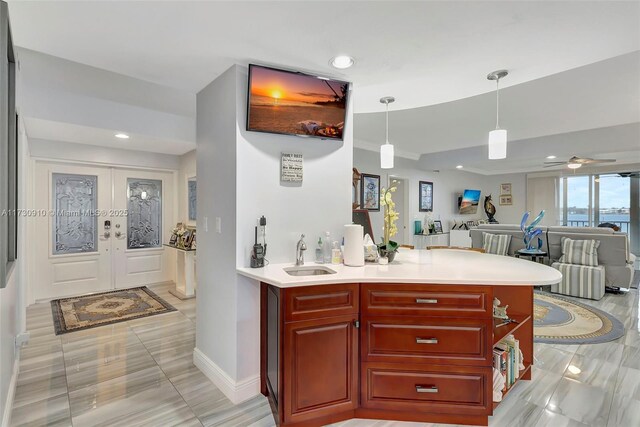 kitchen with a breakfast bar area, kitchen peninsula, wine cooler, and decorative light fixtures