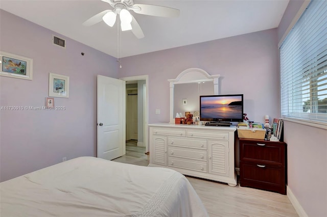 bedroom featuring light hardwood / wood-style floors and ceiling fan