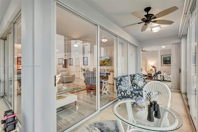 sunroom featuring ceiling fan