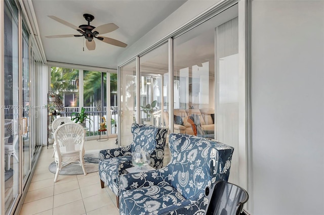 sunroom / solarium featuring ceiling fan