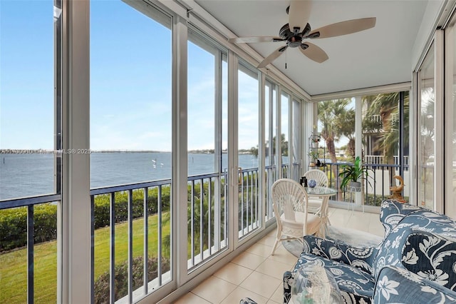 sunroom / solarium featuring a water view, a healthy amount of sunlight, and ceiling fan