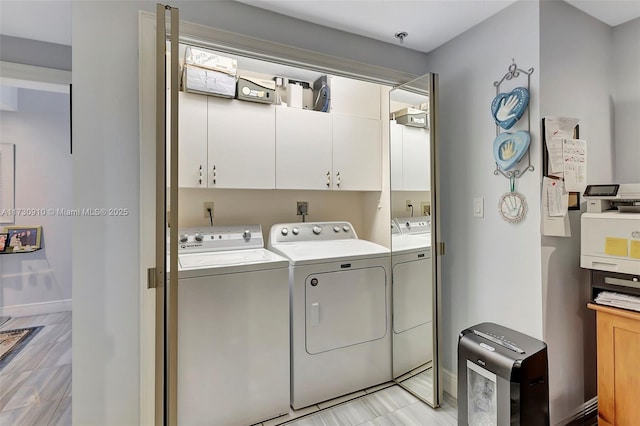 laundry room with cabinets and separate washer and dryer