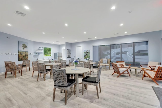 dining space with light hardwood / wood-style flooring