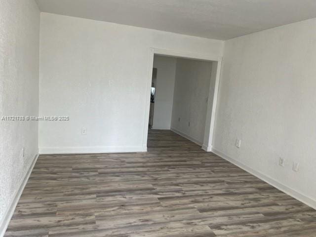 unfurnished room featuring dark hardwood / wood-style flooring