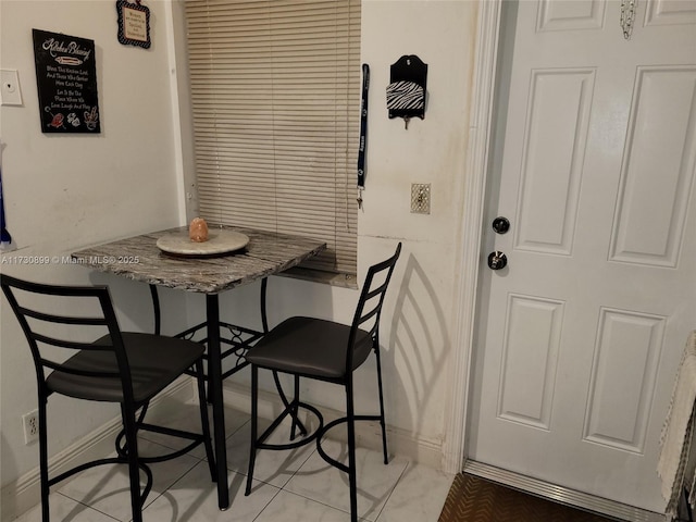 dining area featuring light tile patterned floors