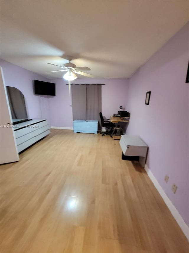 interior space with ceiling fan and light wood-type flooring