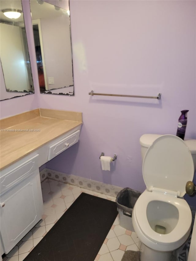 bathroom with vanity, toilet, and tile patterned floors