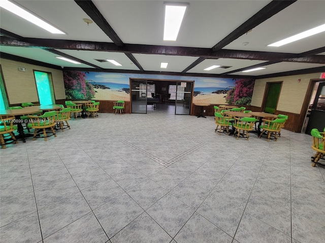 game room with beam ceiling and tile patterned flooring