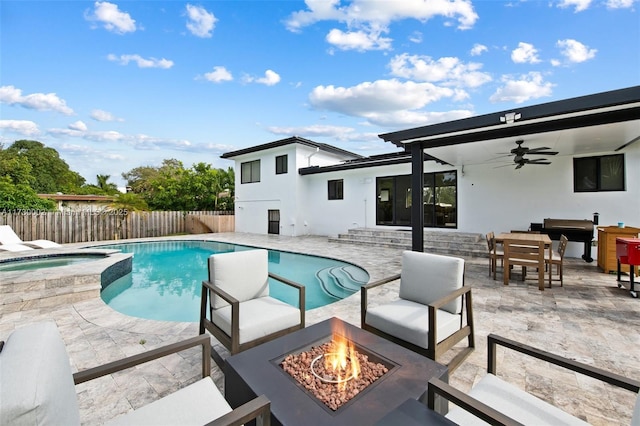 view of swimming pool with an in ground hot tub, a patio area, an outdoor fire pit, and ceiling fan