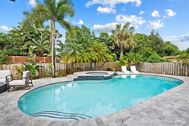 view of pool with an in ground hot tub and a patio