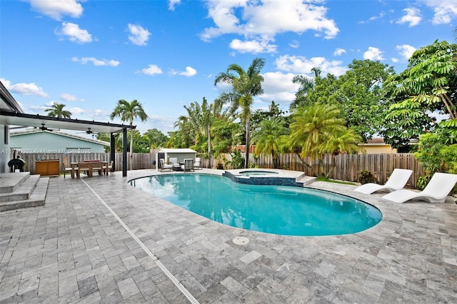 view of pool featuring an in ground hot tub, a patio, and ceiling fan