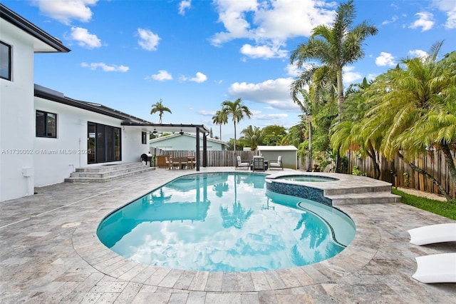 view of swimming pool featuring an in ground hot tub and a patio