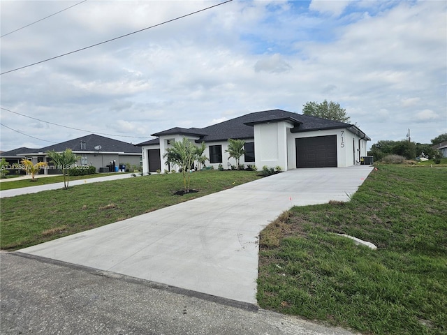 prairie-style home featuring concrete driveway, a front lawn, an attached garage, and stucco siding