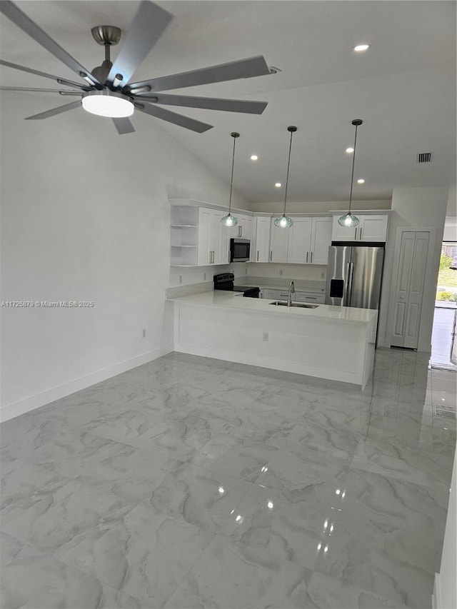 kitchen featuring stainless steel appliances, a peninsula, a sink, white cabinets, and marble finish floor