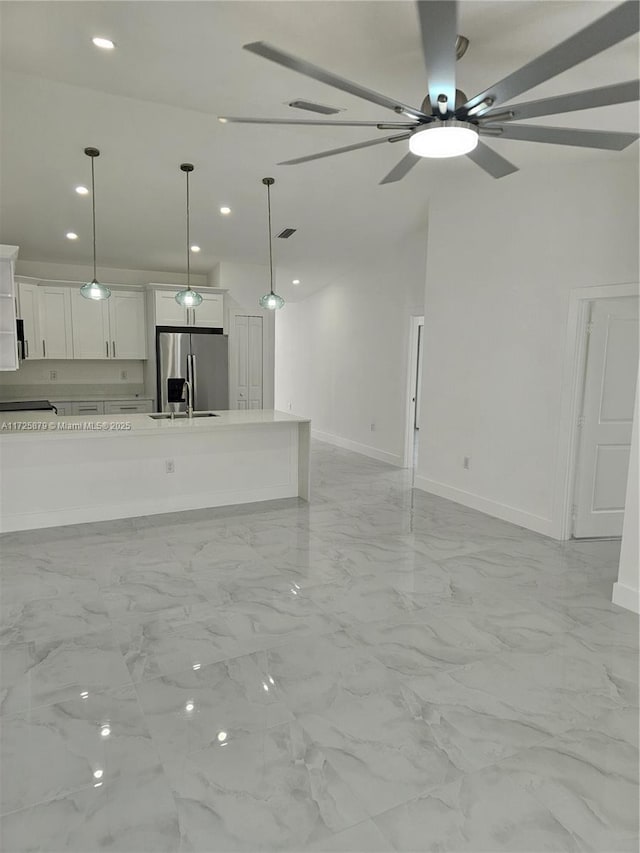 unfurnished living room with ceiling fan, recessed lighting, visible vents, baseboards, and marble finish floor