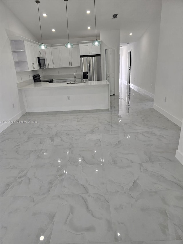 kitchen with open shelves, white cabinetry, stainless steel appliances, and a sink