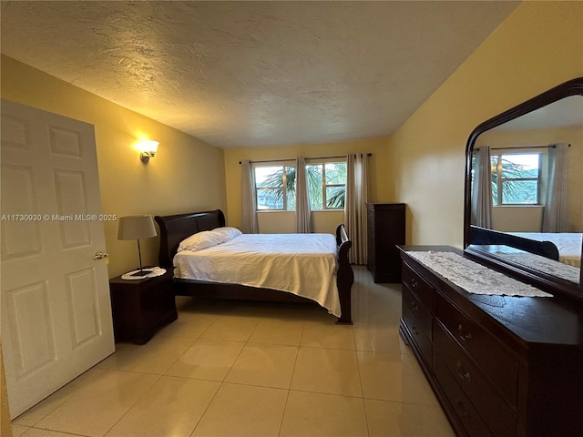 tiled bedroom with a textured ceiling